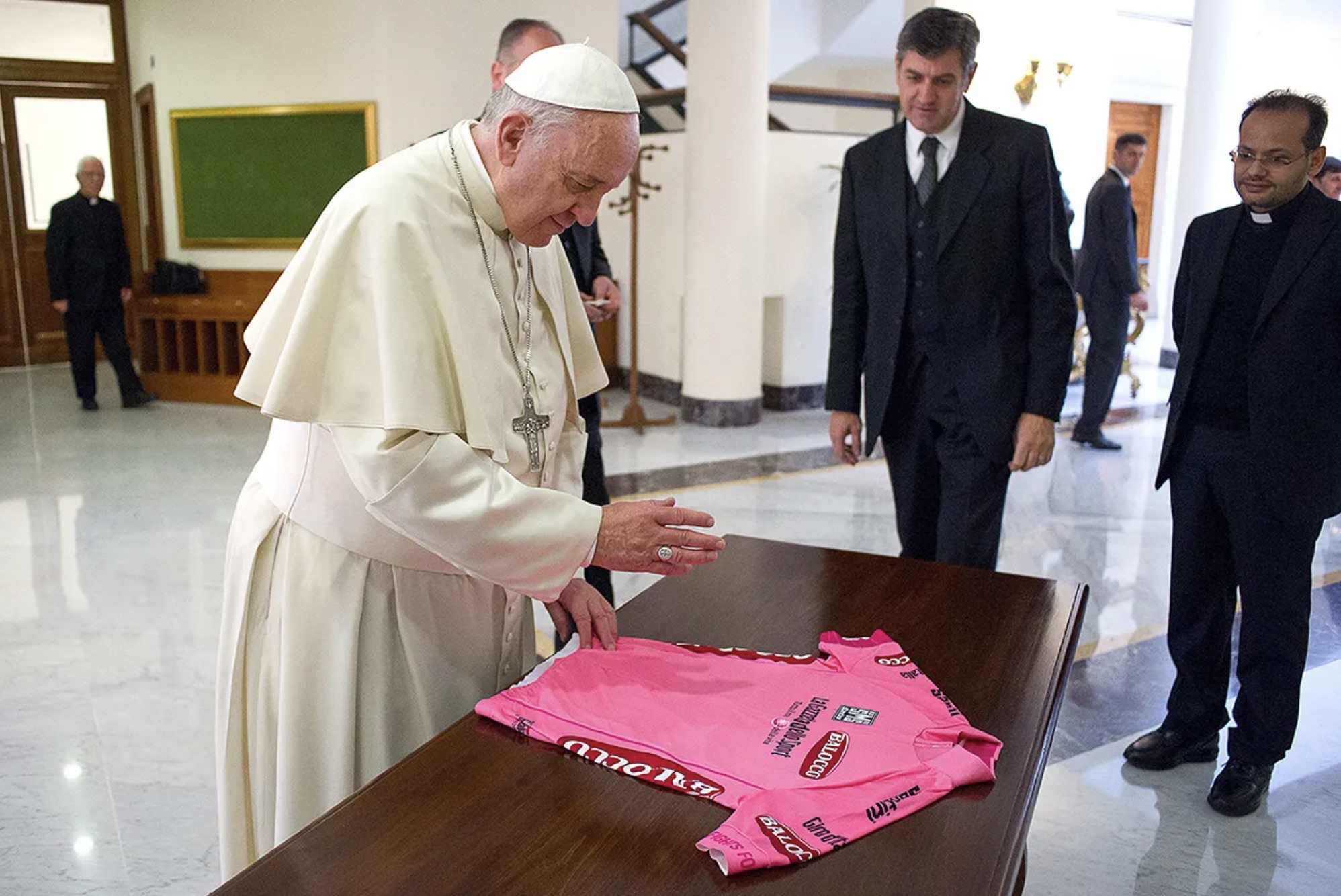 Pope Francis blessing a pink football jersey